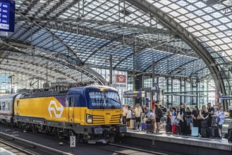 Central station with glass roof construction, crowds of people on the platform, EuroCity, Berlin,