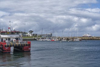 Inland harbour with sailing yachts and offshore supply vessels, passenger ship MS Maud of