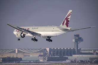 Qatar Airways Cargo Boeing 777F approaching Frankfurt FRA airport, air traffic control tower,