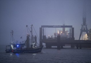 Thick fog in winter, hangs over the mouth of the Elbe into the North Sea, fishing boat, shrimp