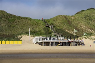 Beach restaurant, Jells aan Zee, on the North Sea beach near Biggekerke, Zeeland, cargo ship