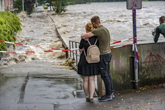 Weir of the Lake Baldeney in Essen, the masses of water roar through the open weirs, spectators,