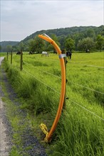 Fibre optic cable, freshly laid along a dirt track, at a paddock, awaiting further expansion,