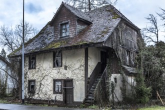 Exterior view of an old house that has been uninhabited for decades and has since been demolished.