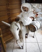 Cloth donkey carrying a male doll and wine barrels, mountain village Langadia, Arcadia,