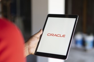 ORACLE logo displayed on smartphone screen. ORACLE is a multinational computer technology