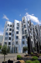 Building by architect Frank O. Gehry with a strikingly corrugated and mirrored surface in