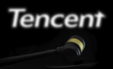 Court gavel in front of the Tencent logo. Tencent Holdings Ltd is a Chinese multinational