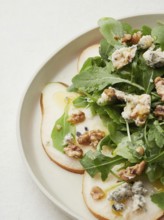 Close-up view of rocket, pear, blue cheese and walnut salad