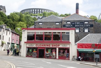 Distillery and shops Oban, Argyll and Bute, Scotland, UK with McCaig's Tower in the background