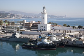 Lighthouse and tug boats in the port of Malaga, Spain, Europe