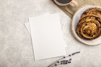 White paper invitation card, mockup with lavender, bun, cup of coffee, linen textile, on gray