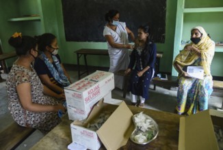 Beneficiaries receives dose of COVID-19 coronavirus vaccine in a vaccination centre at a village in