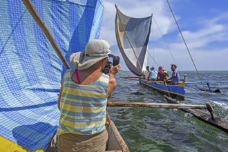 Local fishermen sailing with tourists in traditional fishing boats, outrigger canoes on the Indian