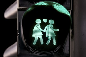 Green pedestrian traffic light with two woman and heart, female traffic light couple, lesbian love,