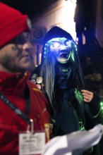 Person with glowing glasses and witch mask at a night carnival party, carnival, Schellbronn night