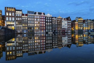 Canal houses on the Damrak, in the centre of the old town of Amsterdam, harbour, starting point of