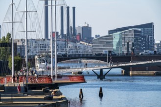 Cyclists on the Cirkelbroen cycle and footpath bridge, over the harbour, in the Christianshavens