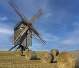 Historic trestle windmill with straw bales Neuenknick Petershagen Germany