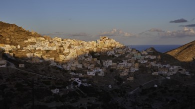 Hilltop town overlooking the sea in the golden morning light, Colourful mountain village, Morning