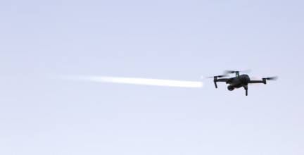 Random image of a radio-controlled drone with contrails, Middle Elbe Biosphere Reserve,