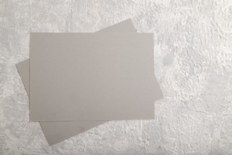 Gray paper business card, mockup on gray concrete background. Blank, flat lay, top view, still