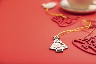 Christmas or New Year composition. Decorations, fir and spruce branches, cup of coffee, on a red