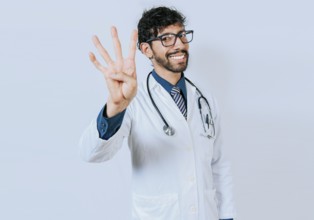 Doctor counting number four isolated. Handsome doctor counting number 4 on isolated background