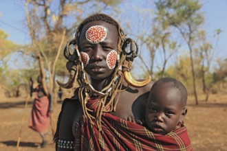 South Ethiopia, in Maco National Park, Mursi tribe, Mursi woman with baby, painted skin and