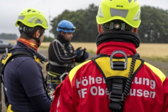 Height rescuers from the Oberhausen fire brigade practise abseiling from a wind turbine from a