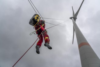 Height rescuers from the Oberhausen fire brigade practise abseiling from a wind turbine from a