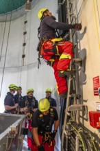 Height rescuers from the Oberhausen professional fire brigade practise abseiling from a wind