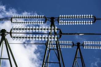 Insulators made of glass on a high-voltage line, they hang on the pylons as a suspension device