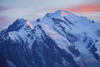 Alpenglow at the summit of Mont Blanc with Aiguille du Midi in the foreground, Savoie, France,