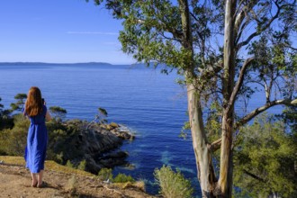 Young woman standing by the sea, coast near Rayol-Canadel-sur-Mer, Corniche des Maures, French