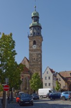 A sunny day with a clear blue sky over a historic tower of St John's Church in Lauf an der Pegnitz,