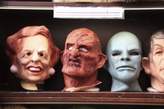 Rubber masks of personalities in a shop window, comically exaggerated depiction of people, Prague,