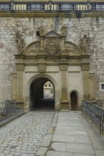 Portal, gate, round arch, bridge, cobblestones, stone figures, coat of arms, relief, decoration,