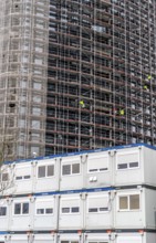 Large construction site, construction of a high-rise residential building, scaffolded shell,