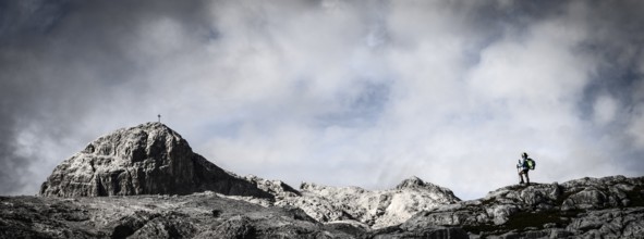 Mountaineer on rocky plateau with summit in the background, Tschagguns, Rätikon, Montafon,