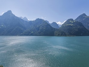 Lake Uri, part of Lake Lucerne near Flüelen, windsurfers in front of the mountains of the Alps.