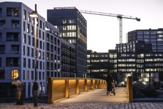 People walk over the Golda Meir footbridge in the Europacity Berlin development area on