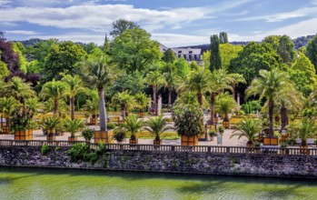 Castle moat with palm garden in the spa gardens, the largest outdoor palm garden north of the Alps,