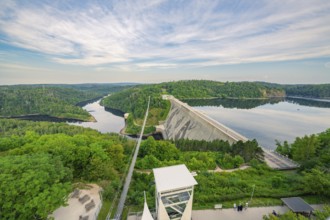 Expansive view of a dam and bridge spanning a river and green forests, Rappbodetalsperre, Harz