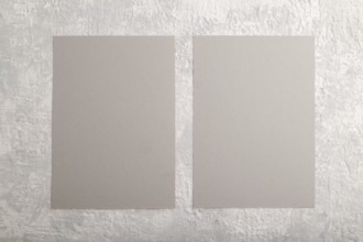 Gray paper business card, mockup on gray concrete background. Blank, flat lay, top view, still