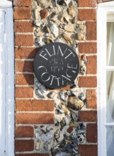 Flint Cottage building detail showing use of red brick and flints at Pettistree, Suffolk, England,