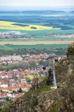 View from the Hexentanzplatz to the cable car, the town of Thale and the Harz foreland with fields