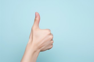 Woman's hand showing thumbs up on blue background. KI generiert, generiert, AI generated