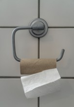 Last sheet of toilet paper on a toilet roll