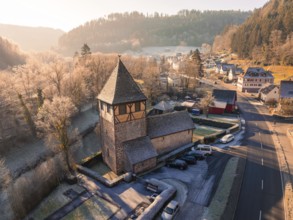 Village with historic church and frosty landscape on a well-travelled road, Kentheim, district of